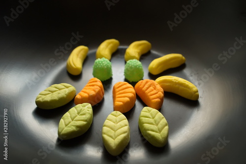 Fruit candy on black. Delicious fruit candy. Multicolored fruit candy.