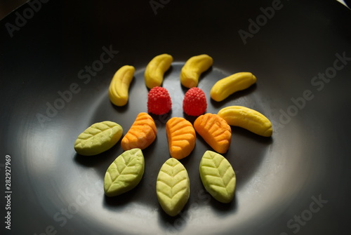 Fruit candy on black. Delicious fruit candy. Multicolored fruit candy.