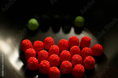 Fruit candy on black. Delicious fruit candy. Multicolored fruit candy.