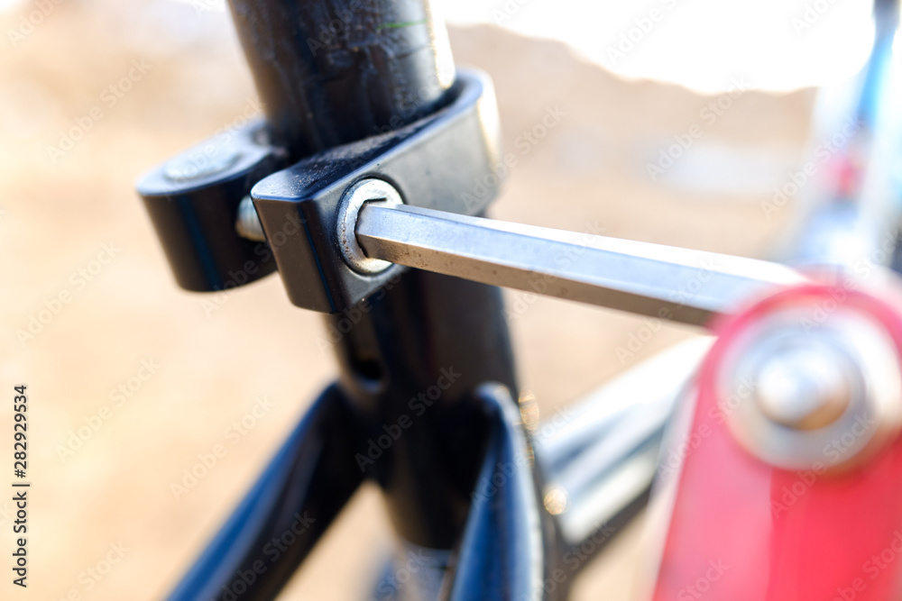 Child tightened the saddle nuts of his bicycle. Child tightened the saddle nuts of his bicycle.