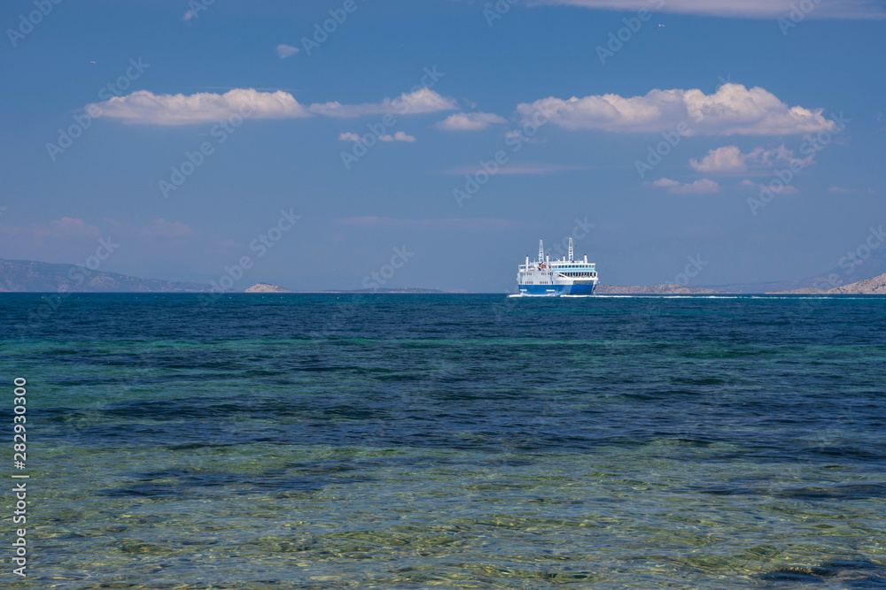 Ferry boat and the blue Mediterranean sea in the Saronic gulf, Greece.