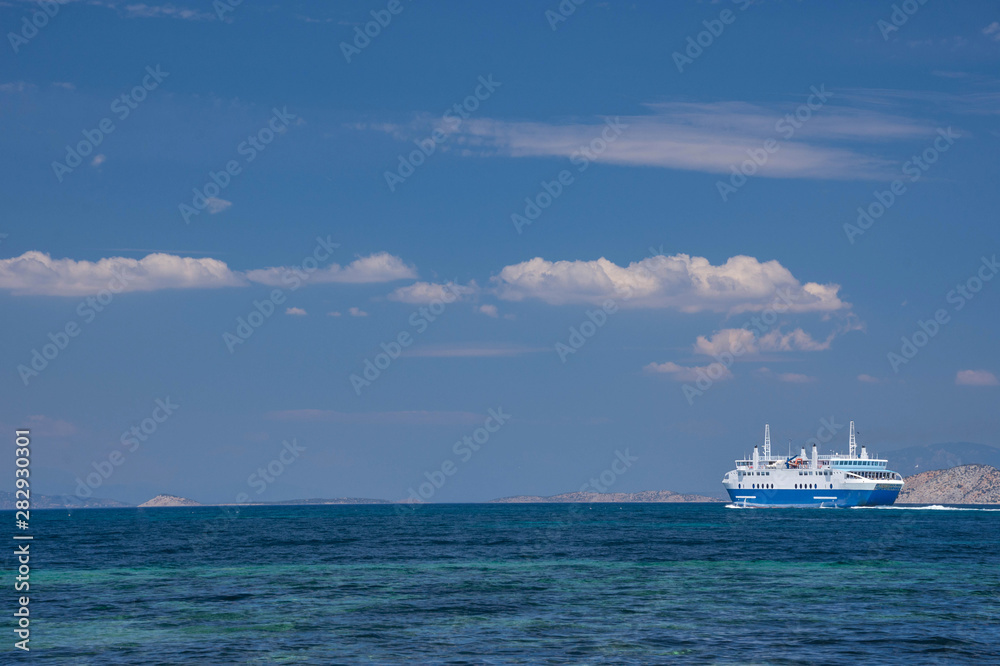 Ferry boat and the blue Mediterranean sea in the Saronic gulf, Greece.