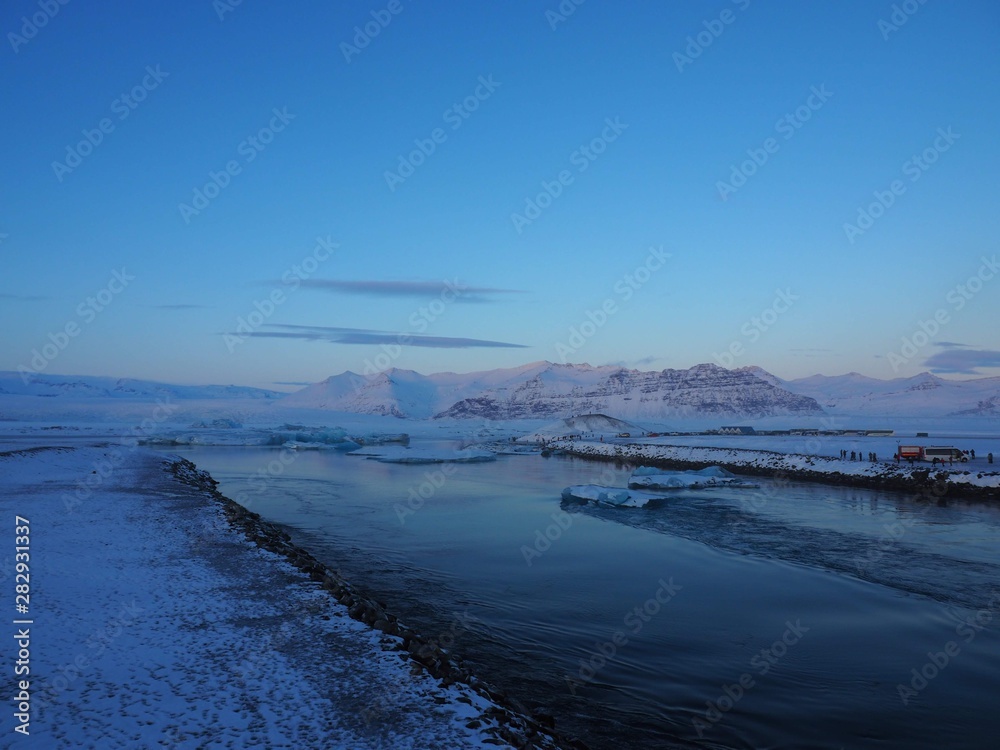 Sea in iceland with icebergs and a blue sky snow in winter 