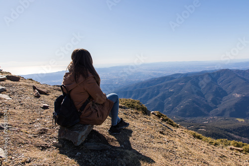 Beautiful woman sitting after hiking during winter or autumn in Catalonia (Turo del Home - Spain)