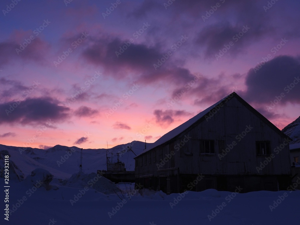 Shadow of a house with a pink side at winter in Iceland