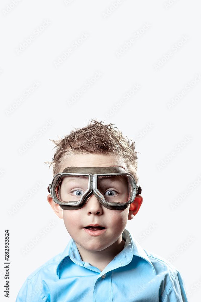 boy in blue shirt and pilot glasses on light background