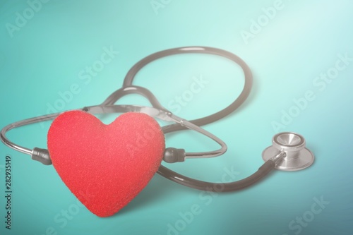 Red heart and a stethoscope on backgrouund