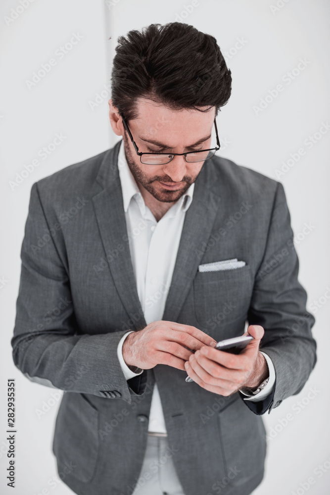 close up. businessman reading SMS on his smartphone. close up. businessman reading SMS on his smartphone.