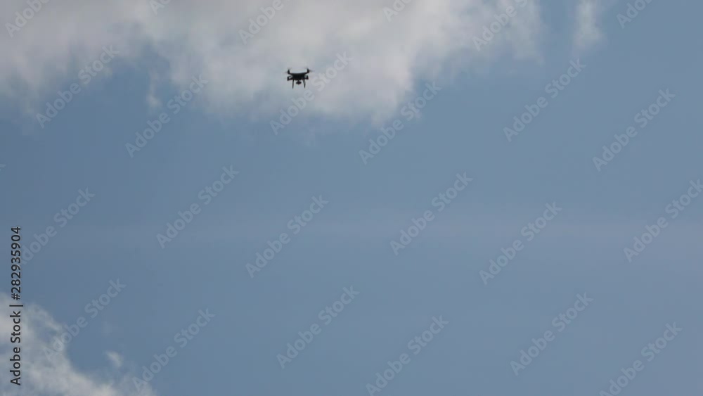 Drone flying in the sky. Quadcopter floats in the air. Drone flying in the sky. Quadcopter floats in the air.