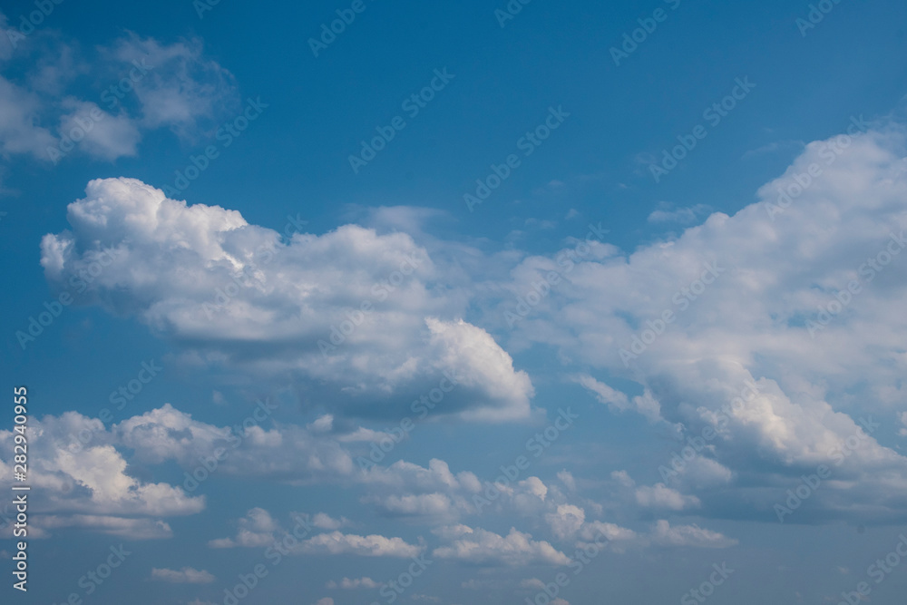 White clouds on the blue sky. Abstract background with clouds on blue sky. In the clear sky high floating clouds. White clouds on the blue sky. Abstract background with clouds on blue sky. In the clear sky high floating clouds.