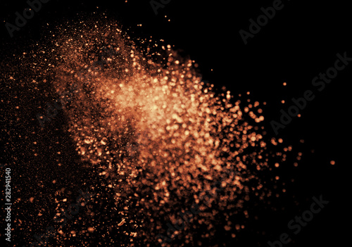 a shot from a firearm, an explosion of gunpowder on a black background, a bright flash with flying particles, abstract shape