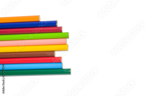 collection of color pencils arranged side by side isolated on white background and copy space; artistic concept