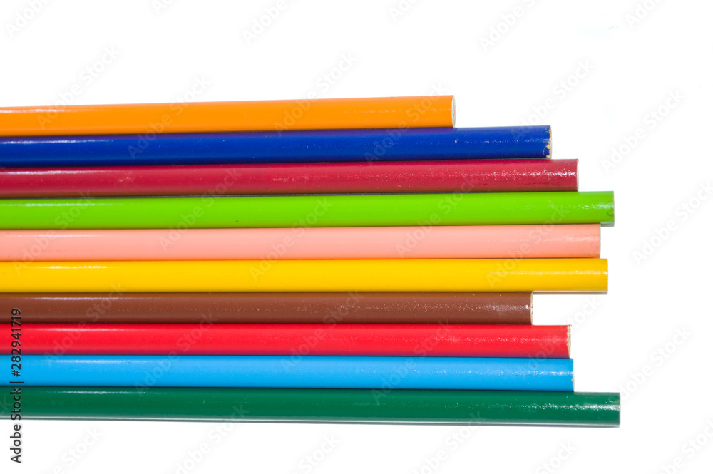 collection of color pencils arranged side by side isolated on white background and copy space; artistic concept collection of color pencils arranged side by side isolated on white background and copy space; artistic concept