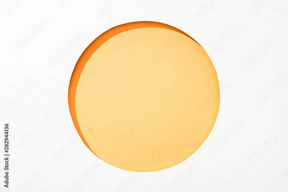 cut out round hole in white paper on yellow colorful background