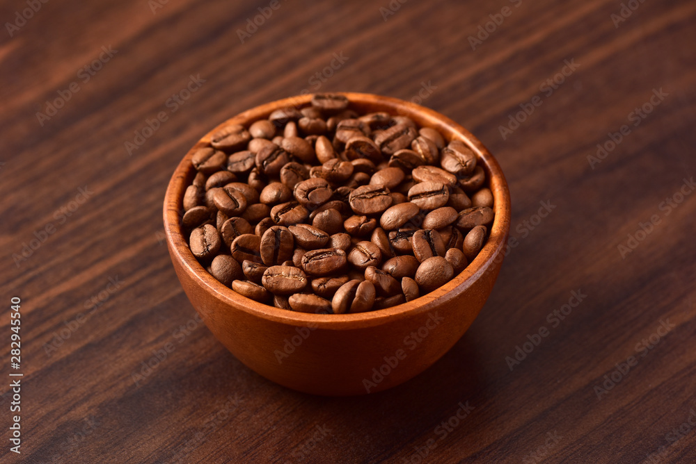 Coffee bens bowl on wooden background Coffee bens bowl on wooden background