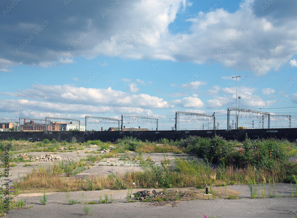 a large unused urban brownfield site with open land covered in cracked overgrown concrete awaiting development in leeds england a large unused urban brownfield site with open land covered in cracked overgrown concrete awaiting development in leeds england