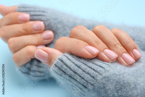 Obraz na plátně Hands of woman with beautiful manicure on color background, closeup