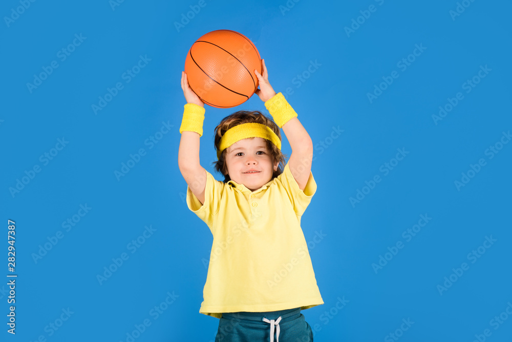 Little basketballer. Basketball training. Sport games. Active lifestyle. Small boy in sportswear throws ball. Sports equipment. Cute boy playing basketball. Enjoy sport game. Kid sport activities.