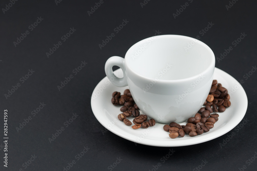 White cup of coffee and coffee beans isolated on black background White cup of coffee and coffee beans isolated on black background