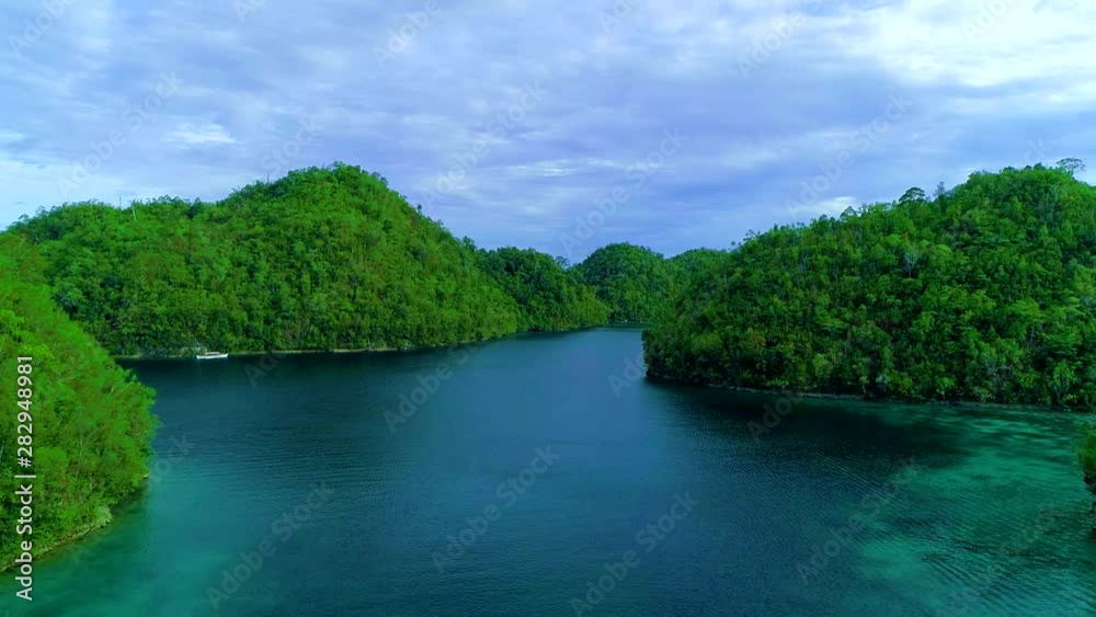 Tropical landscape rainforest hills and azure water in lagoon with clouds on the Siargao island, Philippines. Drone Aerial view 4Kl Tropical landscape rainforest hills and azure water in lagoon with clouds on the Siargao island, Philippines. Drone Aerial view 4Kl