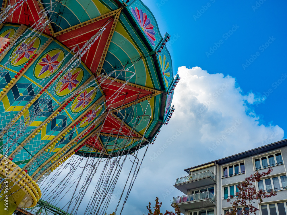 Fototapeta premium colorful merry-go-round against blue sky