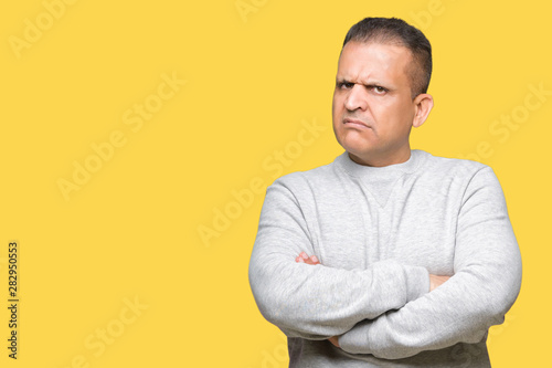 Middle age arab man wearing sport sweatshirt over isolated background skeptic and nervous, disapproving expression on face with crossed arms. Negative person.