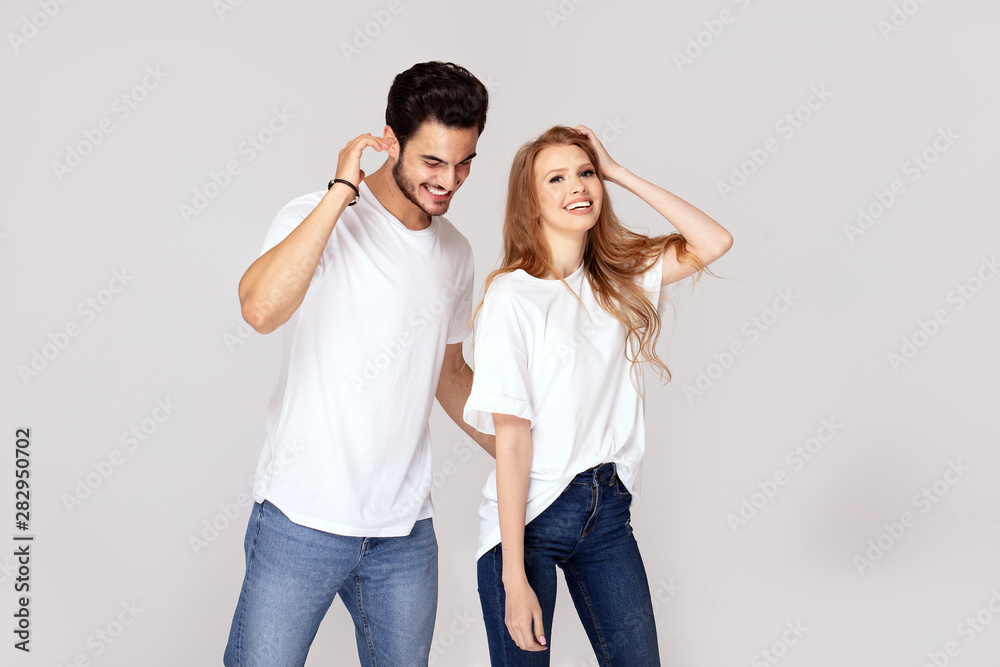 Happy youg couple posing together in studio. Happy youg couple posing together in studio.