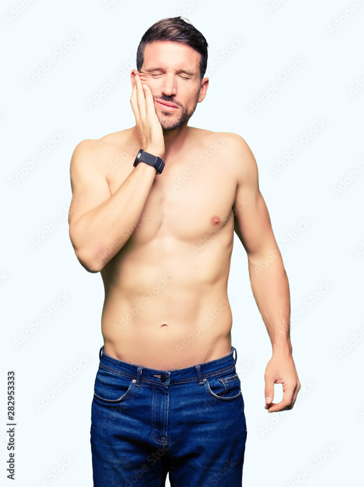 Fototapeta premium Handsome shirtless man showing nude chest touching mouth with hand with painful expression because of toothache or dental illness on teeth. Dentist concept.