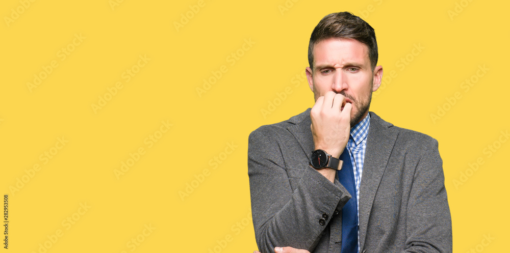Handsome business man wearing suit and tie looking stressed and nervous with hands on mouth biting nails. Anxiety problem. Handsome business man wearing suit and tie looking stressed and nervous with hands on mouth biting nails. Anxiety problem.