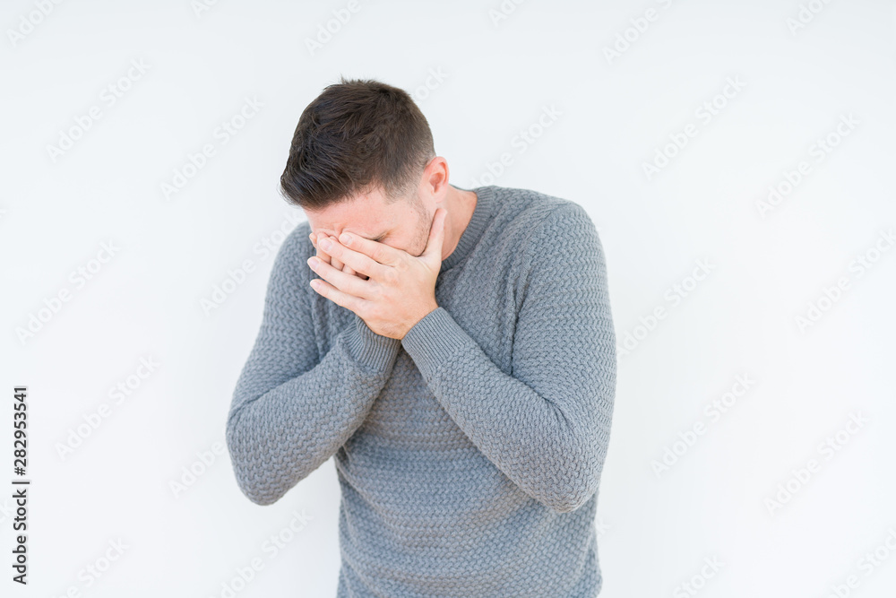Young handsome man wearing casual sweater over isolated background with sad expression covering face with hands while crying. Depression concept. Young handsome man wearing casual sweater over isolated background with sad expression covering face with hands while crying. Depression concept.