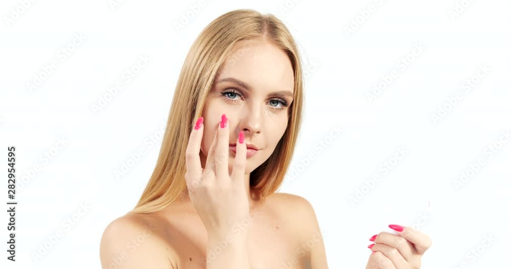 Attractive blonde woman opening jar and applying face cream, skin moisturizing, beauty procedures Attractive blonde woman opening jar and applying face cream, skin moisturizing, beauty procedures