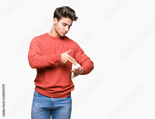 Young handsome man over isolated background In hurry pointing to watch time, impatience, upset and angry for deadline delay
