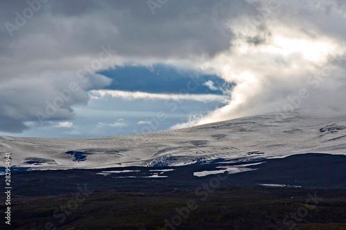 mountain landscape with contrasting clouds in Iceland.