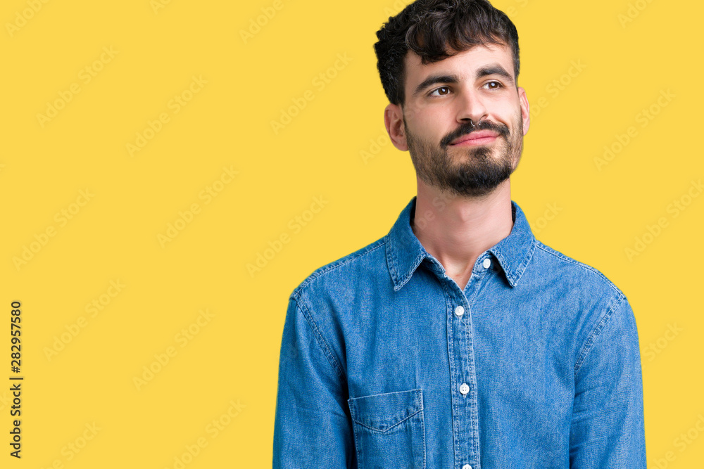 Young handsome man over isolated background smiling looking side and staring away thinking. Young handsome man over isolated background smiling looking side and staring away thinking.
