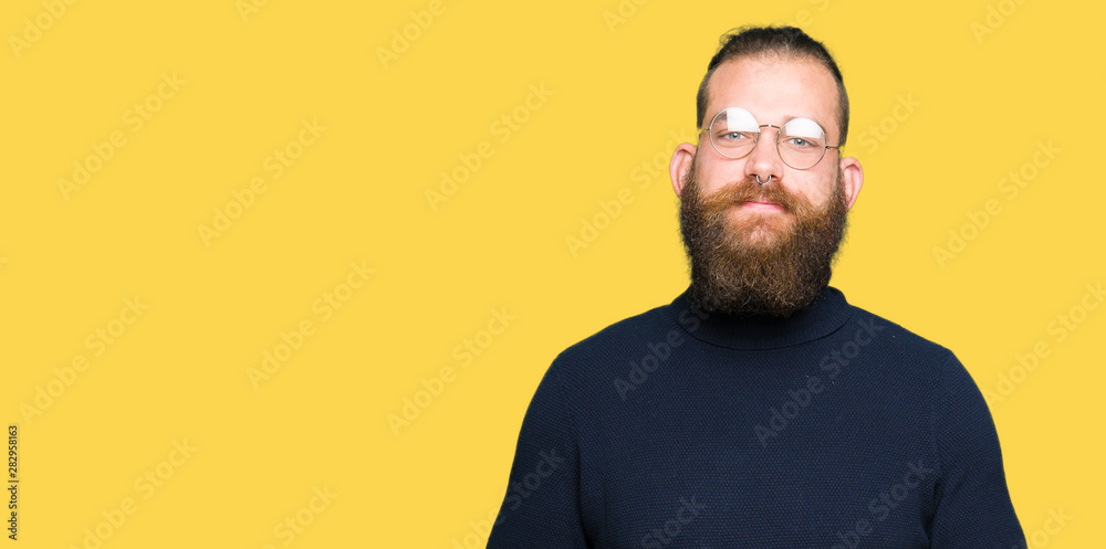 Young blond man wearing glasses and turtleneck sweater Hands together and fingers crossed smiling relaxed and cheerful. Success and optimistic Young blond man wearing glasses and turtleneck sweater Hands together and fingers crossed smiling relaxed and cheerful. Success and optimistic