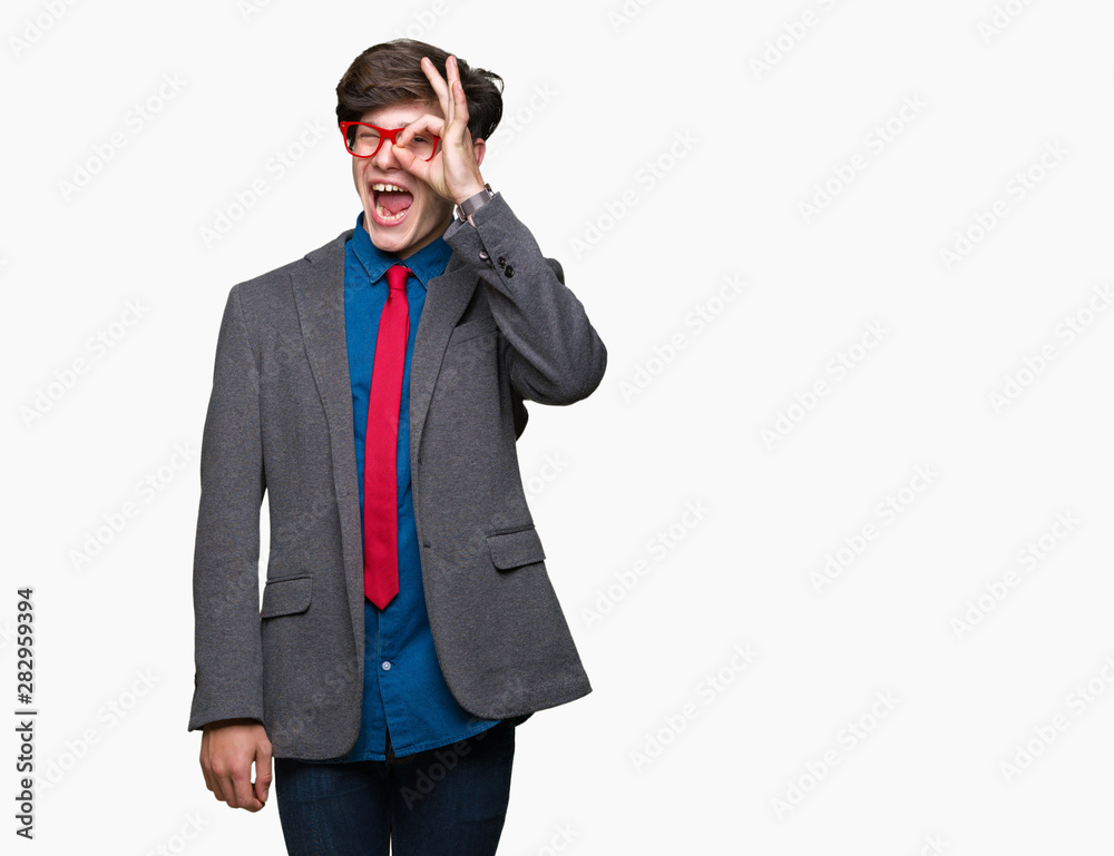 Young handsome business man wearing red glasses over isolated background doing ok gesture with hand smiling, eye looking through fingers with happy face. Young handsome business man wearing red glasses over isolated background doing ok gesture with hand smiling, eye looking through fingers with happy face.