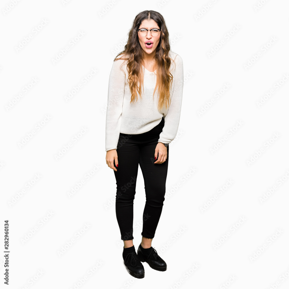 Young beautiful woman wearing glasses afraid and shocked with surprise expression, fear and excited face. Young beautiful woman wearing glasses afraid and shocked with surprise expression, fear and excited face.