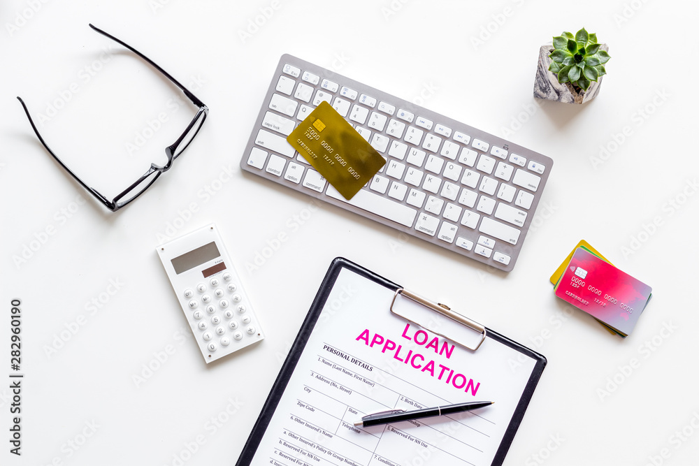 loan application with credit cards and keyboard on banker work place white background top view loan application with credit cards and keyboard on banker work place white background top view