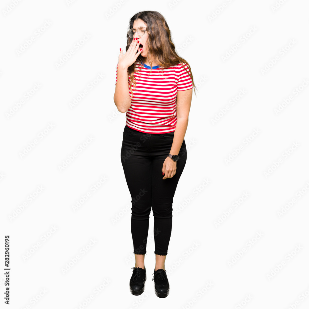 Fototapeta premium Young beautiful woman wearing glasses bored yawning tired covering mouth with hand. Restless and sleepiness.
