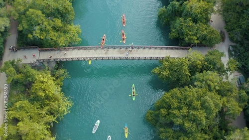 Cinematic 4K Aerial Footage of Bridge over Creek Ending with a Top Down Shot featuring people in Kayaks on the water photo