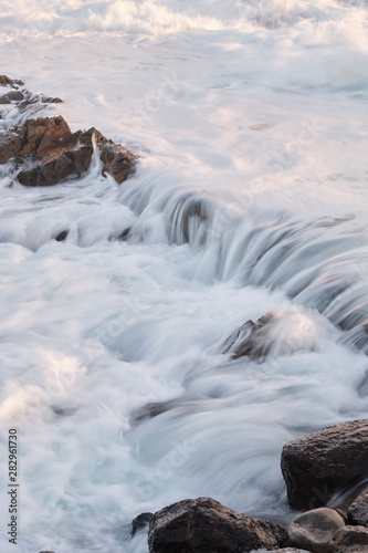 Water flow motion over rocks during big swell in Australia