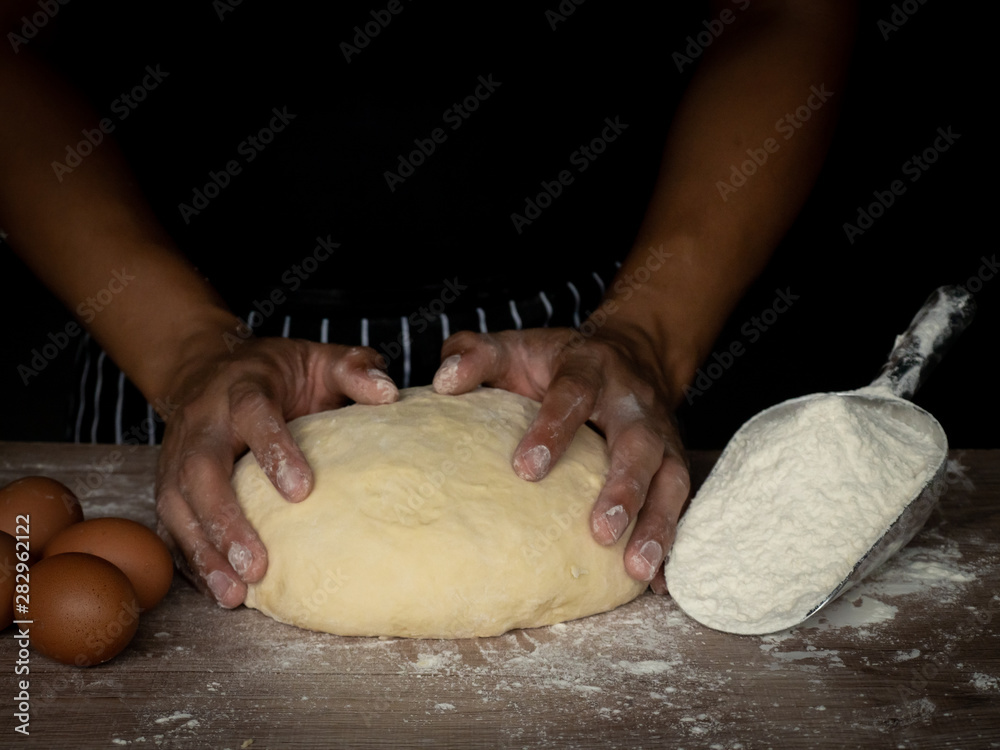 Cook is creating a dough to make bread. Cook is creating a dough to make bread.