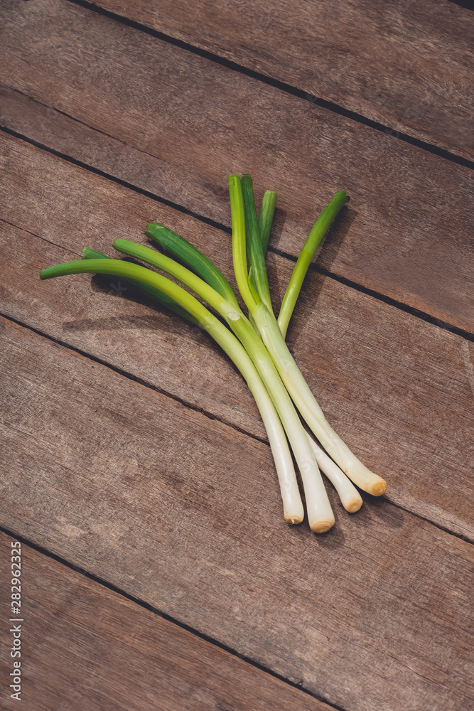 Japanese fresh green scallion or onion on wooden table background Japanese fresh green scallion or onion on wooden table background