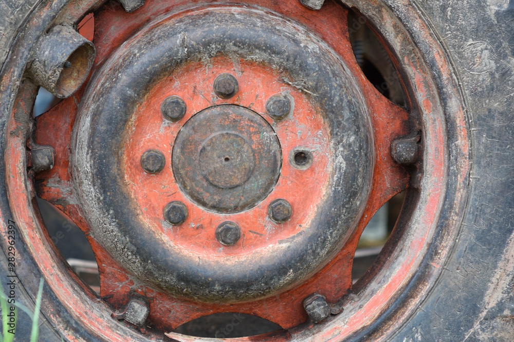 Old rusty nuts and bolt joint on tractor wheel. Old rusty nuts and bolt joint on tractor wheel.