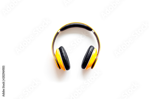 Audio listening with wireless headphones on white background top view space for text