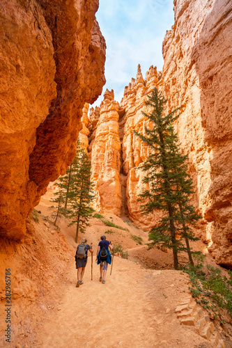 Two adult women hiking in Bryce Canyon National Park, Utah, USA while on vacation. Candid photo, view from behind