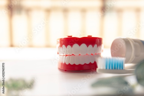 Close up Denture with toothpaste Toothbrush on blurred background.Metaphor for oral  dentures jaw toothy healthcare protect.