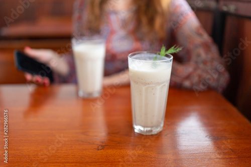 glass of milk on wooden table