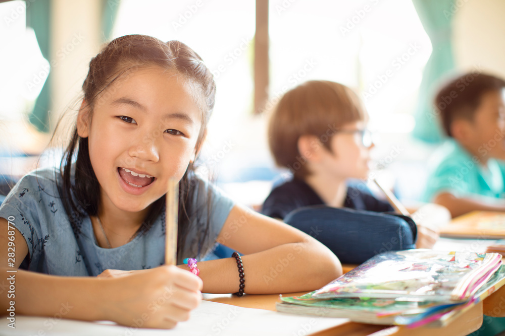 Smiling elementary school kids in classroom Smiling elementary school kids in classroom
