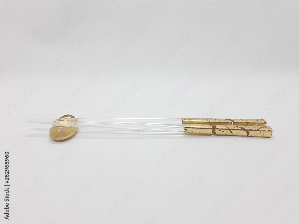 Japanese Elegant Luxury Modern Classic Golden Transparent Chopstick in White Isolated Background Japanese Elegant Luxury Modern Classic Golden Transparent Chopstick in White Isolated Background